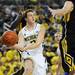 Michigan freshman Spike Albrecht looks to pass the ball around Iowa defense in the second half at Crisler Center on Sunday, Jan. 6. Michigan beat Iowa 95-67 in the Big Ten home opener. Melanie Maxwell I AnnArbor.com